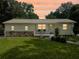 Charming single-story home with well-maintained lawn and front porch seating under a beautiful sunset sky at 1537 Ne 22Nd St, Ocala, FL 34470