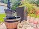 Artistic water fountain feature nestled in a backyard garden with a decorative pot and brick patio under natural lighting at 1537 Ne 22Nd St, Ocala, FL 34470