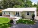 Charming single story home with a metal roof, well manicured front lawn, and a welcoming front porch at 1537 Ne 22Nd St, Ocala, FL 34470