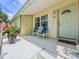 Inviting front porch with comfortable seating and a decorative floral arrangement, adding charm to the home at 1537 Ne 22Nd St, Ocala, FL 34470