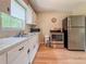 Bright kitchen showcasing stainless steel appliances, tiled countertops, and wood-look floors at 1537 Ne 22Nd St, Ocala, FL 34470