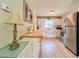 Functional kitchen with stainless steel refrigerator, white cabinetry, and a wooden countertop at 1537 Ne 22Nd St, Ocala, FL 34470