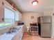 Kitchen with stainless steel appliances, tiled countertops, and wood-look floors at 1537 Ne 22Nd St, Ocala, FL 34470