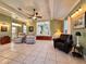 Large living room with tile flooring, comfortable seating, and seamless flow to dining area at 1537 Ne 22Nd St, Ocala, FL 34470