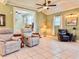 Bright living room features tile flooring, comfortable seating, and a view into the dining area at 1537 Ne 22Nd St, Ocala, FL 34470