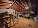 Interior of shed with exposed beams, plywood floor, workbench, and assorted tools and equipment at 1537 Ne 22Nd St, Ocala, FL 34470