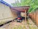 Close-up of the shed's covered area, showcasing a lawn mower parked neatly under the wooden structure at 1537 Ne 22Nd St, Ocala, FL 34470