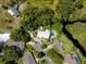 Aerial view of a home, showcasing a large private pool, manicured landscaping, and natural surroundings at 15733 Tower View Dr, Clermont, FL 34711