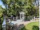 Relaxing outdoor deck area with seating, grill, and views of lush greenery and the canal at 15733 Tower View Dr, Clermont, FL 34711