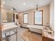 Charming bathroom with a clawfoot tub, tiled floor, a glass shower, and vintage-style fixtures at 15733 Tower View Dr, Clermont, FL 34711