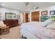 Spacious bedroom with carpet, a large bed, wood trim and a dresser with a vintage mirror at 15733 Tower View Dr, Clermont, FL 34711