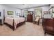 Bedroom with a vintage bed, wood furniture, and soft lighting creating a relaxing atmosphere at 15733 Tower View Dr, Clermont, FL 34711