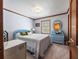 Cozy bedroom with blue decor, a comfortable bed, and natural light from the window at 15733 Tower View Dr, Clermont, FL 34711