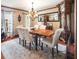 Formal dining room featuring a chandelier, hardwood floors, ample seating for six, and a large antique grandfather clock at 15733 Tower View Dr, Clermont, FL 34711