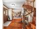 Elegant foyer boasts hardwood flooring, a grand staircase, and views of the formal dining room at 15733 Tower View Dr, Clermont, FL 34711
