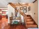 Warm foyer with hardwood floors, wood staircase, and decorative accents, exuding a welcoming ambiance at 15733 Tower View Dr, Clermont, FL 34711