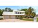 Two-story house featuring a well-kept front yard, brick driveway, water fountain, and a two-car garage at 15733 Tower View Dr, Clermont, FL 34711