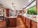Beautiful kitchen featuring wood floors, custom cabinets, granite countertops, an island with barstool seating, and modern appliances at 15733 Tower View Dr, Clermont, FL 34711