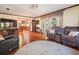 Inviting living room featuring hardwood floors, neutral tones, and direct access to the kitchen and outdoor patio at 15733 Tower View Dr, Clermont, FL 34711