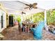 Inviting covered patio with brick floors, ceiling fans, and a comfortable seating area perfect for outdoor relaxation at 15733 Tower View Dr, Clermont, FL 34711