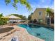 Backyard pool surrounded by brick pavers and comfortable seating areas at 15733 Tower View Dr, Clermont, FL 34711