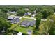 Aerial view of the home, showcasing the screened lanai, large backyard, shed, and established trees at 15828 Se 98Th Ter, Summerfield, FL 34491