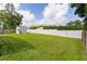 Lush green backyard featuring a storage shed, mature landscaping and a white vinyl fence at 15828 Se 98Th Ter, Summerfield, FL 34491