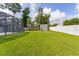 Beautiful backyard featuring a green lawn, a storage shed, and a white vinyl privacy fence at 15828 Se 98Th Ter, Summerfield, FL 34491