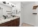 Bathroom features double sink with granite countertop and updated lighting at 15828 Se 98Th Ter, Summerfield, FL 34491