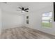 This home features a light and airy bedroom with wood-look floors at 15828 Se 98Th Ter, Summerfield, FL 34491