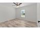 This light and bright bedroom includes wood-look flooring and ceiling fan at 15828 Se 98Th Ter, Summerfield, FL 34491