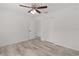 Light bedroom features wood-look flooring, ceiling fan, and closet at 15828 Se 98Th Ter, Summerfield, FL 34491