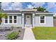 Charming front entry featuring a decorative door, well-kept walkway, and manicured landscaping at 15828 Se 98Th Ter, Summerfield, FL 34491