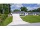 Beautifully landscaped single-story home with a two-car garage, and a well-maintained lawn at 15828 Se 98Th Ter, Summerfield, FL 34491