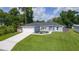 Attractive single-story home with a lush green lawn and a convenient two-car garage at 15828 Se 98Th Ter, Summerfield, FL 34491
