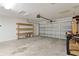 Bright garage with a storage rack on the wall next to the door, and a utility space at 15828 Se 98Th Ter, Summerfield, FL 34491
