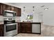 Updated kitchen with stainless steel appliances, granite counters, and modern lighting at 15828 Se 98Th Ter, Summerfield, FL 34491