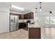 Modern kitchen featuring granite countertops, stainless steel appliances, and dark wood cabinets at 15828 Se 98Th Ter, Summerfield, FL 34491