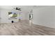 Bright living room with wood-look floors, ceiling fan, and seamless flow into other spaces at 15828 Se 98Th Ter, Summerfield, FL 34491