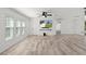 Open living area featuring wood-look floors, ceiling fan, and great natural light at 15828 Se 98Th Ter, Summerfield, FL 34491