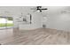 Spacious living area with wood-look floors, opening to the kitchen and outdoor patio at 15828 Se 98Th Ter, Summerfield, FL 34491