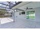 Sliding glass doors off of the patio lead inside this grey home with a tiled patio area at 15828 Se 98Th Ter, Summerfield, FL 34491