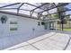 Covered patio featuring a fan and exterior access to the backyard and screened patio area at 15828 Se 98Th Ter, Summerfield, FL 34491
