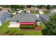 Aerial view of the home highlighting the screened lanai, backyard, and manicured landscaping at 16730 Se 78Th Lillywood Ct, The Villages, FL 32162