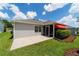 Well-maintained backyard featuring a screened lanai with awning and a concrete patio at 16730 Se 78Th Lillywood Ct, The Villages, FL 32162