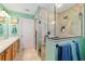 Bright bathroom featuring a glass shower enclosure, double sink vanity and modern fixtures at 16730 Se 78Th Lillywood Ct, The Villages, FL 32162
