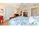 A bedroom featuring hardwood floors, neutral walls, and a view into the bathroom at 16730 Se 78Th Lillywood Ct, The Villages, FL 32162