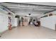 Spacious garage with epoxy floors, ample storage cabinets, and convenient access doors at 16730 Se 78Th Lillywood Ct, The Villages, FL 32162