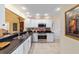 Well-lit kitchen featuring stainless steel appliances, white cabinets, and a gas range at 16730 Se 78Th Lillywood Ct, The Villages, FL 32162