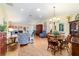 Living room and dining area with hardwood floors, natural light, and stylish furniture at 16730 Se 78Th Lillywood Ct, The Villages, FL 32162
